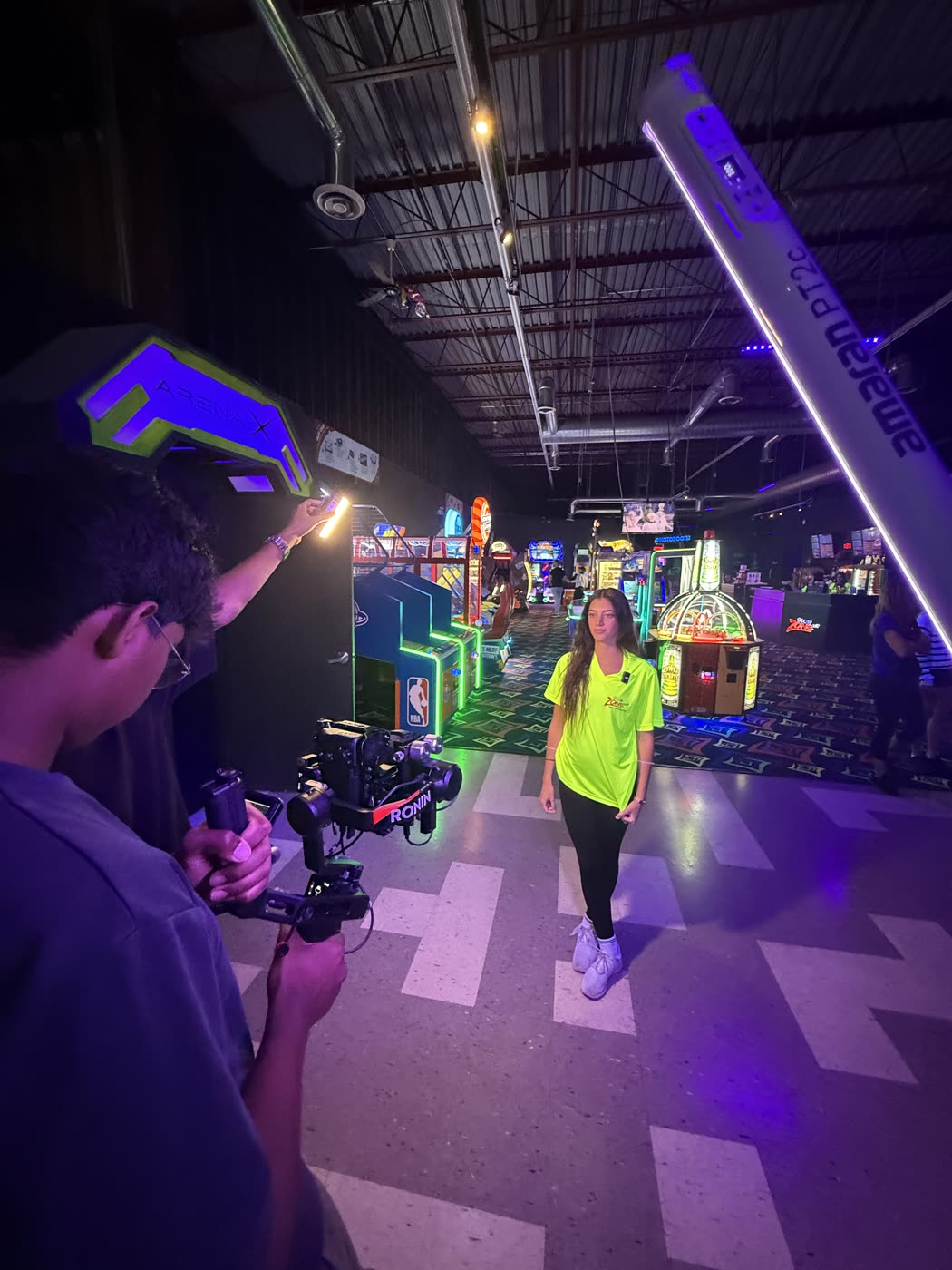 A videographer following the action on a gimbal during an arcade shoot.