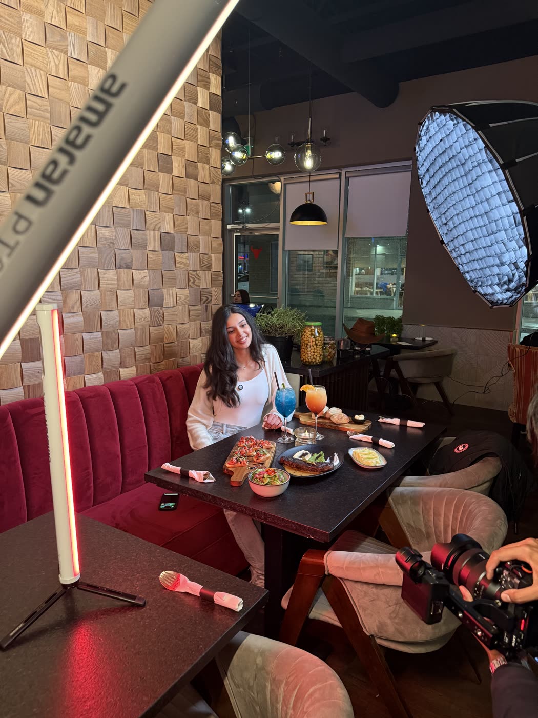 A VentureX shoot in progress inside a restaurant, with the crew set up around the table.